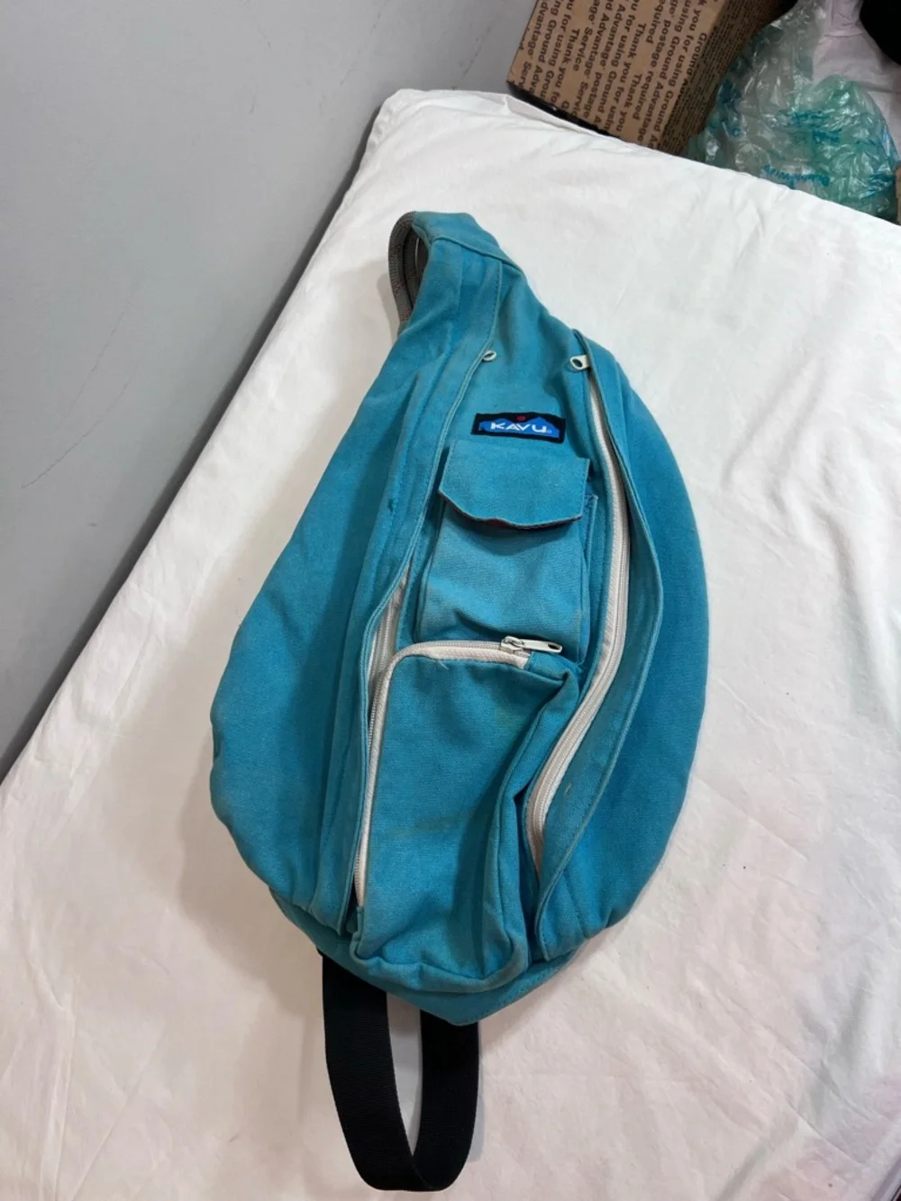 Kavu teal rope sling bag backpack